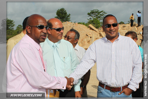 Minister of Sports, Anil Roberts, shakes hands with the Trinidad Rocket Sheldon Bissessar